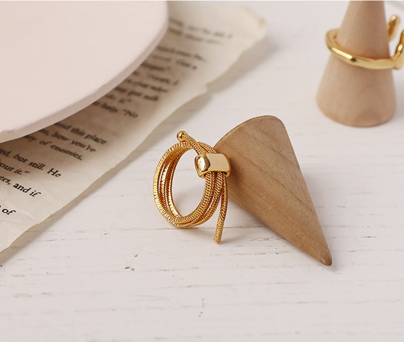 ALODIA ENTANGLE RING IN BRASS WITH 18K GOLD FINISH ADJUSTABLE