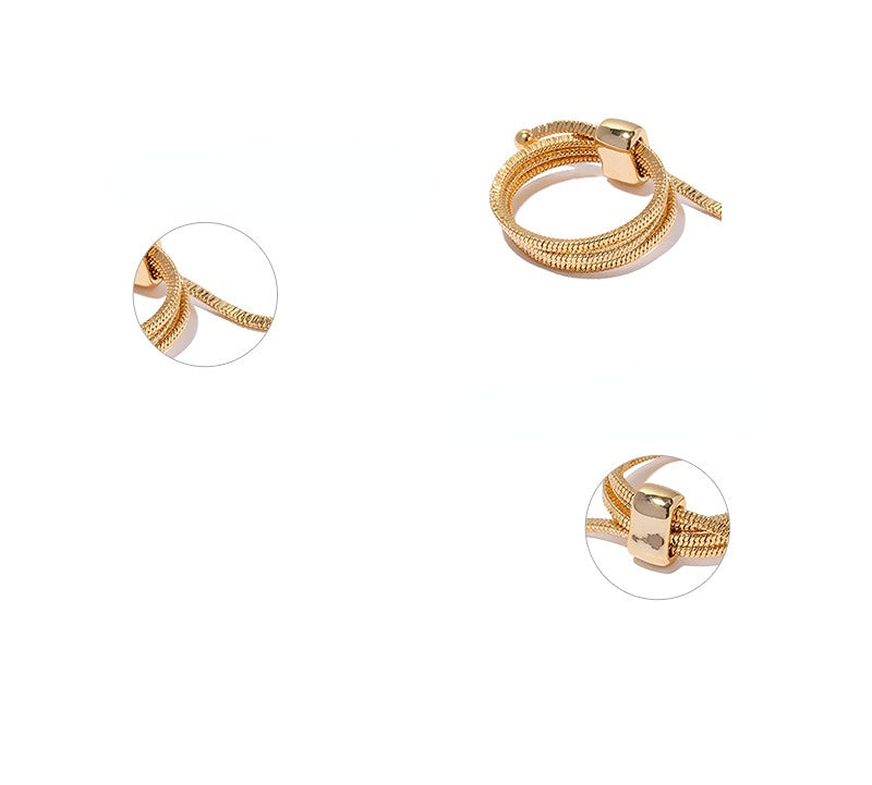 ALODIA  ENTANGLE RING IN BRASS WITH 18K GOLD FINISH  ADJUSTABLE